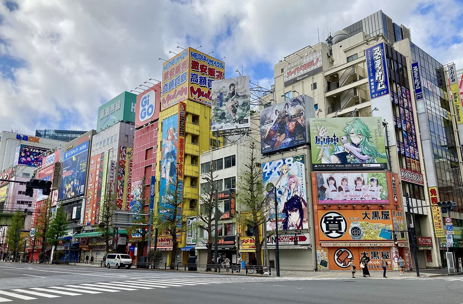 Anime and game billboards covering the buildings along Chuo-dori in Akihabara on a sunny day