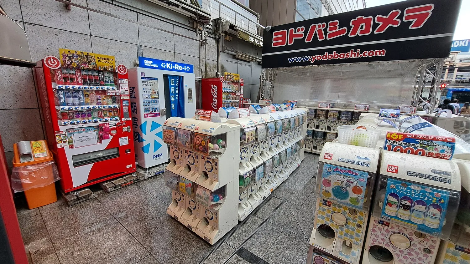 Rows of capsule toy machines on the pavement outside Yodobashi Camera near Akihabara Station