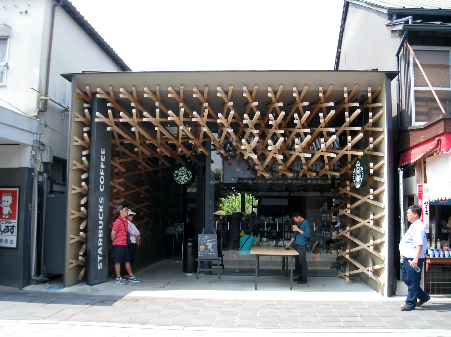 A shop front framed by a dense lattice of crossed wooden sticks