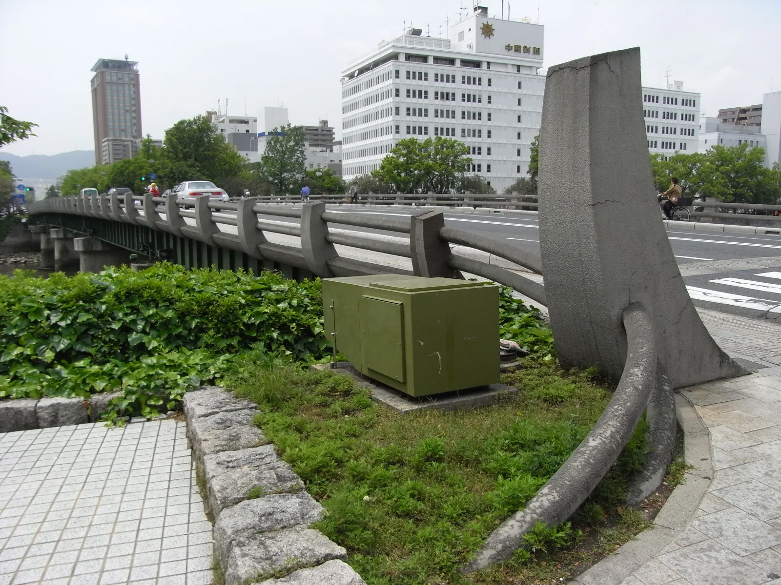 The sculpted concrete railing of West Peace Bridge, curving at the end of the bridge