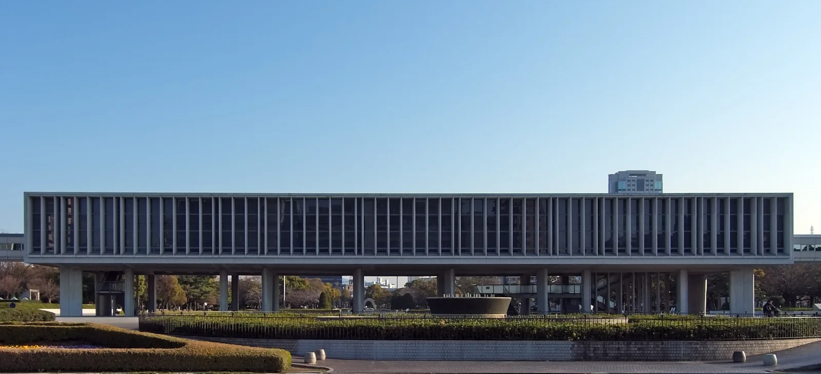 The long, low main building of the Peace Memorial Museum raised on columns above open ground