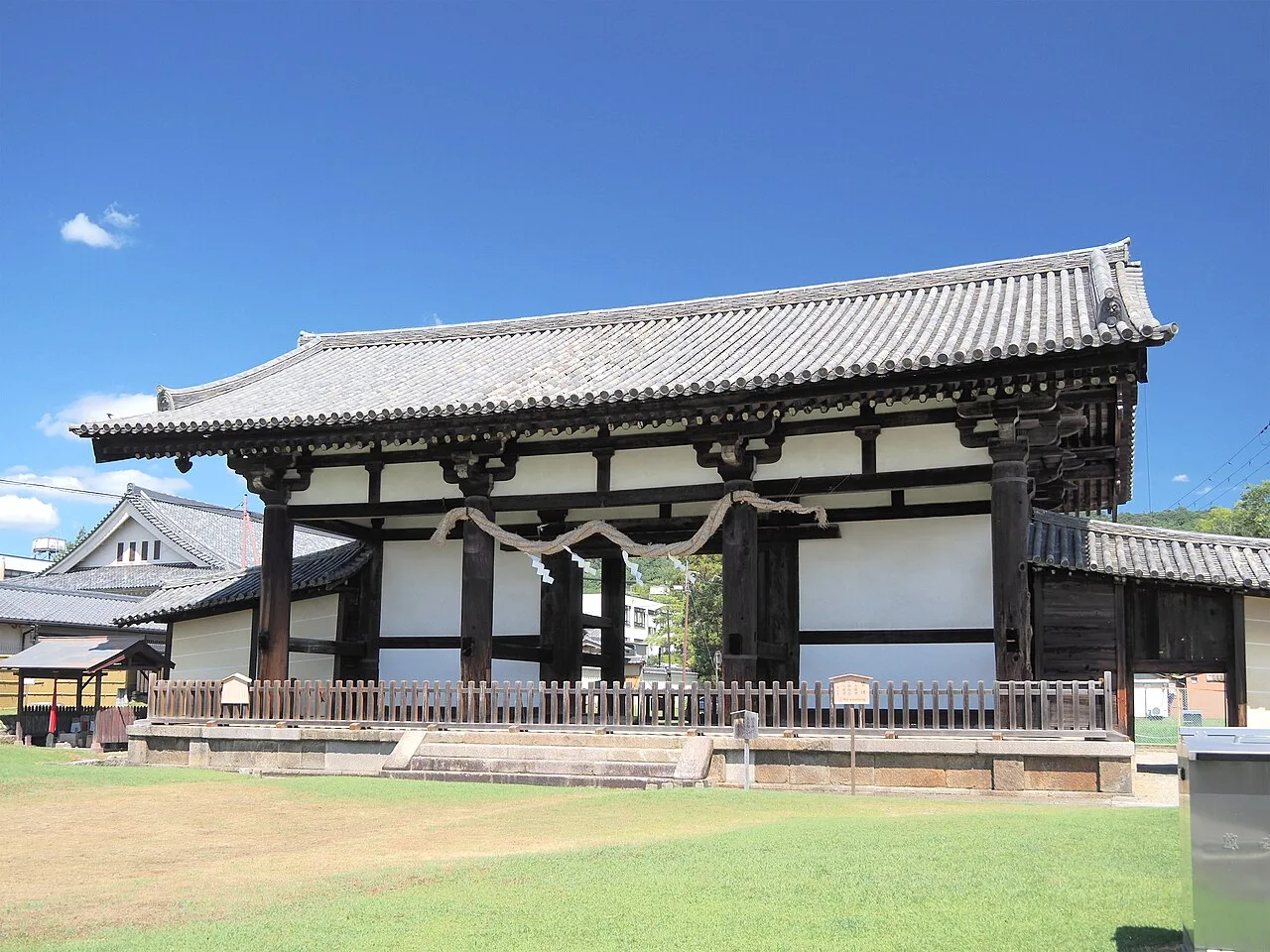 Tegaimon at Todai-ji, a large wooden gate with a tiled roof standing on an open lawn